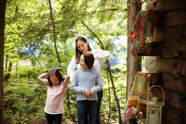 Caucasian mother brushing hair of daughter