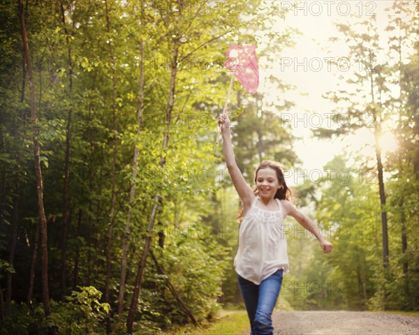 Caucasian girl carrying butterfly net