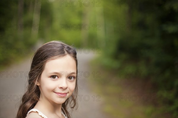 Caucasian girl smiling on dirt road