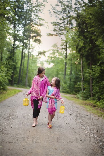 Caucasian sisters walking on dirt road