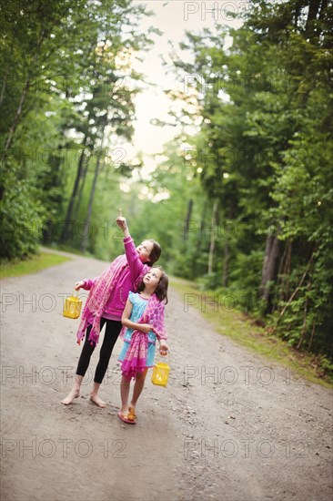 Caucasian sisters admiring forest view