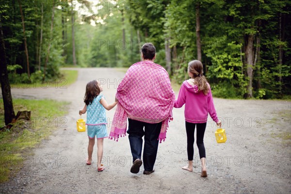 Caucasian grandmother and granddaughters on rural road