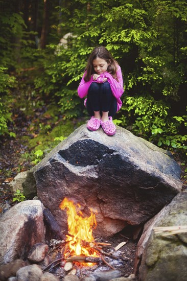 Caucasian girl admiring campfire