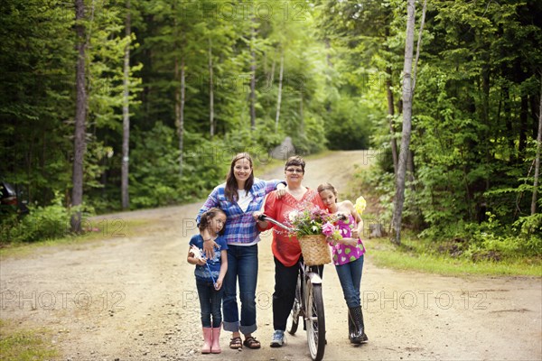 Three generations of Caucasian women standing on dirt road