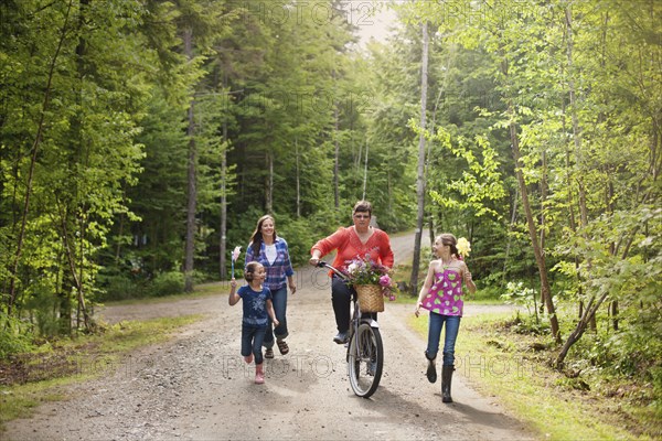 Three generations of Caucasian women walking on dirt road