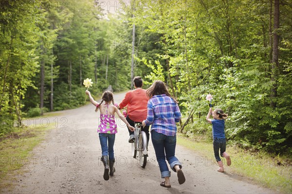 Three generations of Caucasian women walking on dirt road