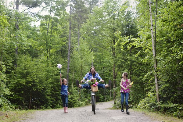 Three generations of Caucasian women walking on dirt road