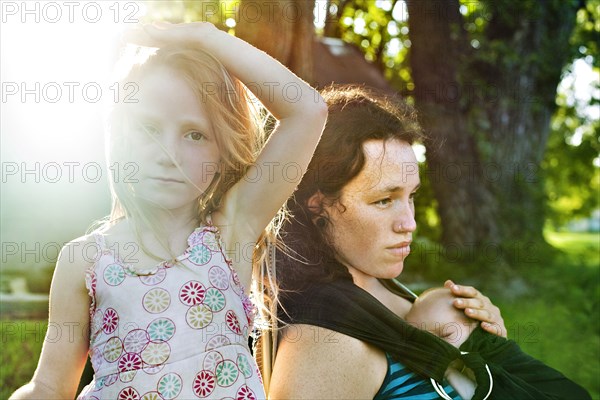 Serious mother and children outdoors