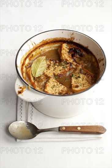 Pot of stewed meat with spoon