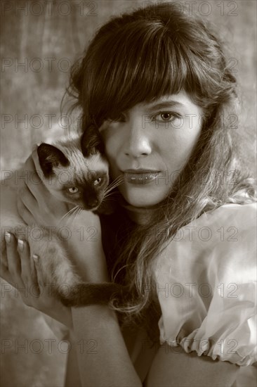 Caucasian woman holding kitten