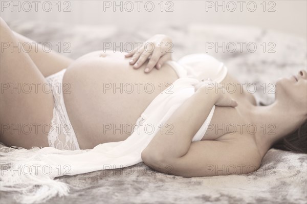 Pregnant Caucasian woman laying