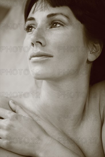 Nude Caucasian woman looking up