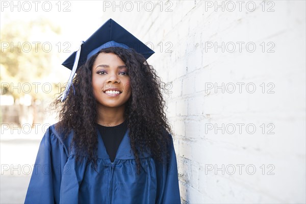 Black graduate wearing cap and gown