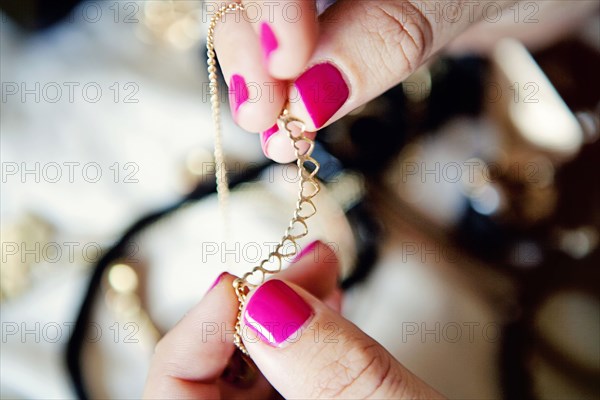 Close up of woman holding jewelry