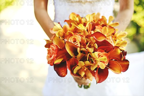 Bride carrying bouquet of flowers