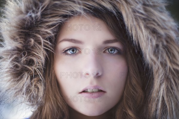 Close up of woman wearing fur hood