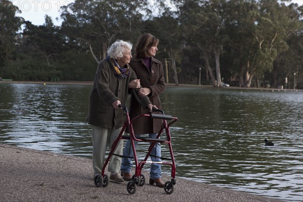 Woman walking with mother at pond