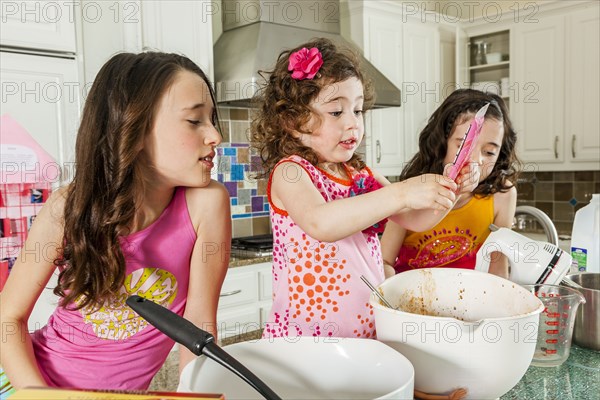 Sisters baking in kitchen