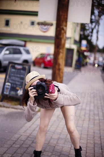 Caucasian woman photographing outdoors