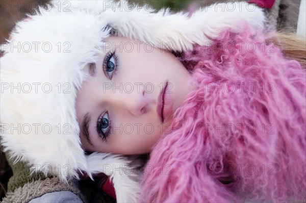 Caucasian teenage girl wearing fuzzy hat