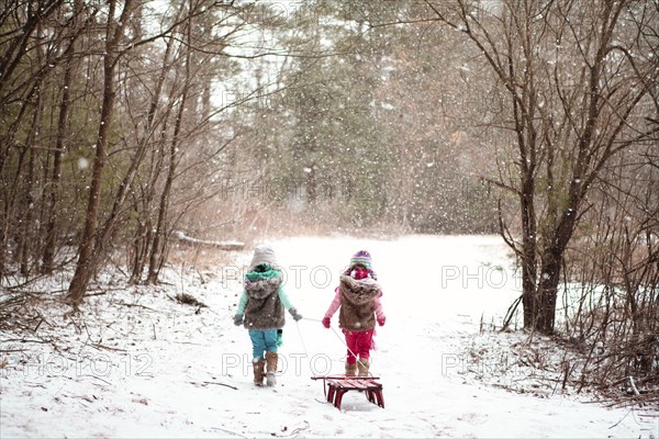 Girls walking in snowy field