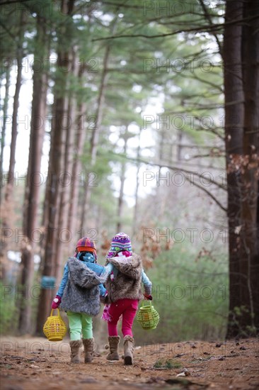 Caucasian girls walking in forest