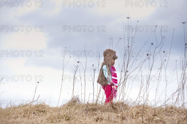 Caucasian girl walking on hilltop