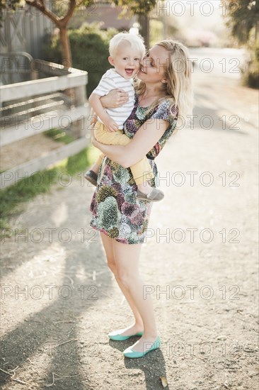 Mother holding son outdoors