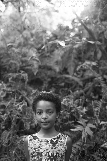 Smiling girl standing in forest