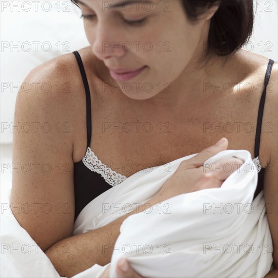 Hispanic woman holding blanket