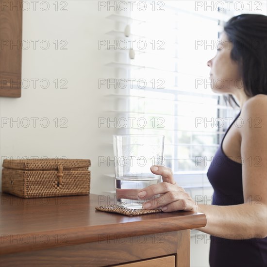 Hispanic woman drinking water