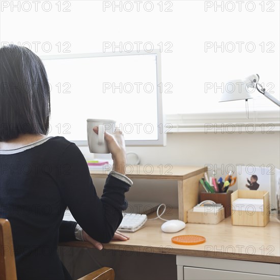 Hispanic woman working in home office