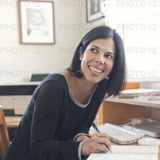 Hispanic woman working in home office