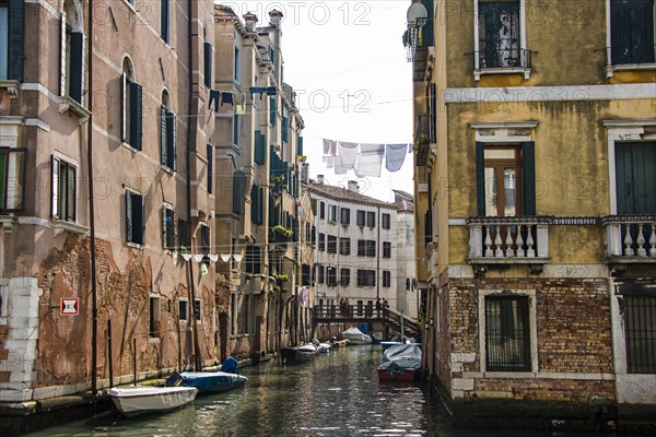 Clotheslines over canal between apartment buildings