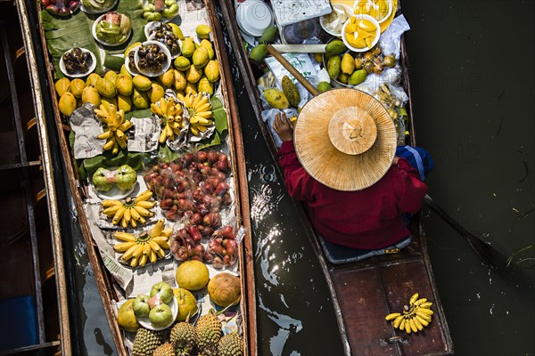 High angle view of merchant selling fruit in canoe