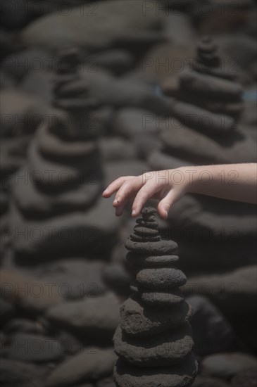 Close up of hand stacking rocks