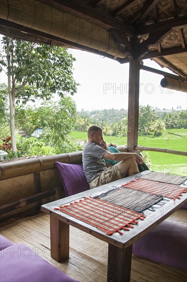 Caucasian couple relaxing on balcony