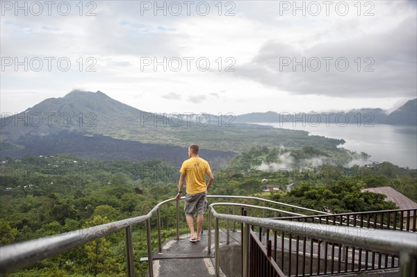 Caucasian tourist admiring scenic view of jungle