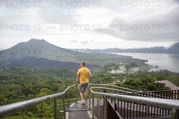 Caucasian tourist admiring scenic view of jungle