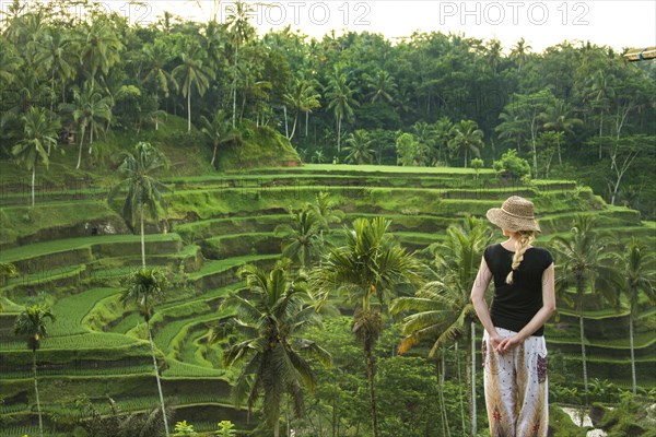 Caucasian tourist admiring rural rice terrace