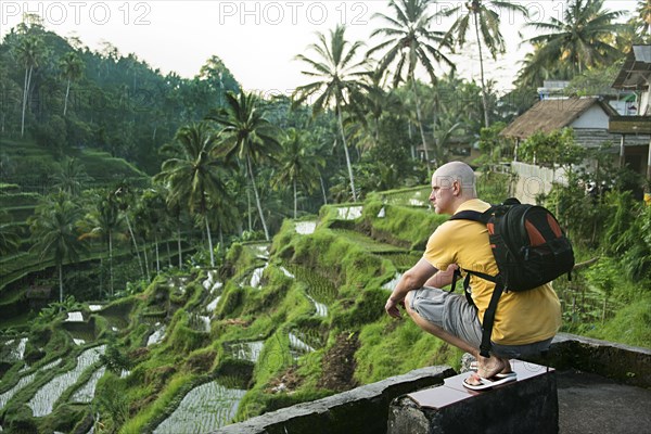 Caucasian tourist admiring rural rice terrace