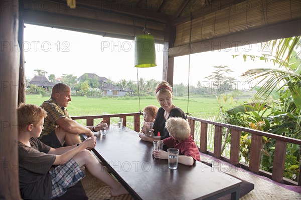 Caucasian family eating in covered patio