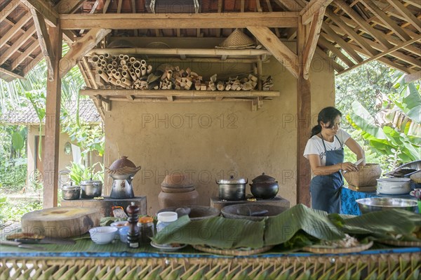 Asian chef cooking in outdoor kitchen