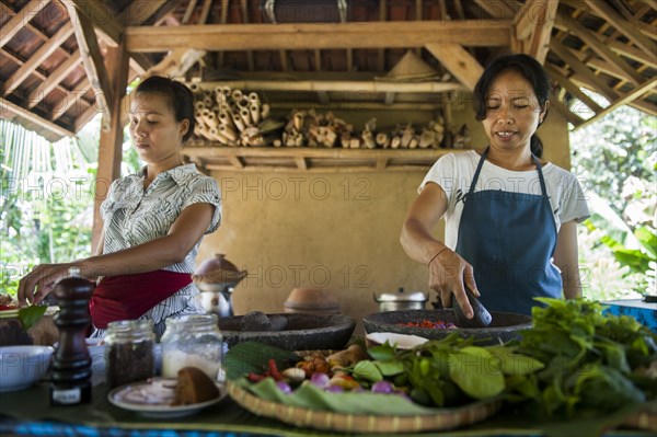 Asian chefs cooking in outdoor kitchen