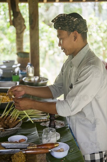Asian chef cooking in outdoor kitchen