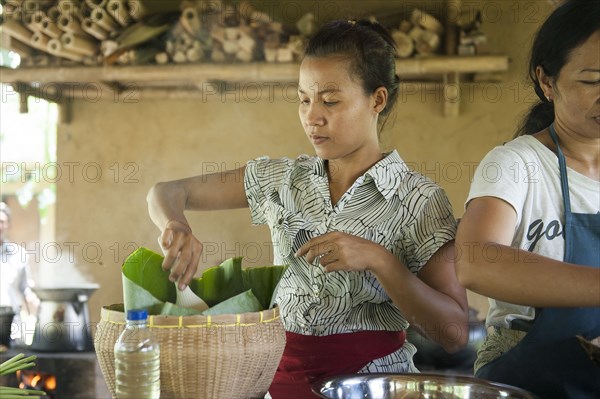 Asian chefs cooking in outdoor kitchen