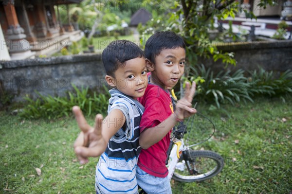 Asian boys playing in backyard