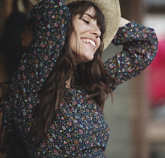 Smiling Caucasian woman dancing outdoors