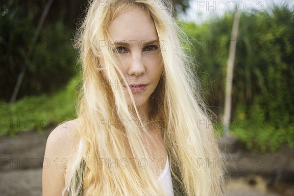 Serious Caucasian woman standing on beach