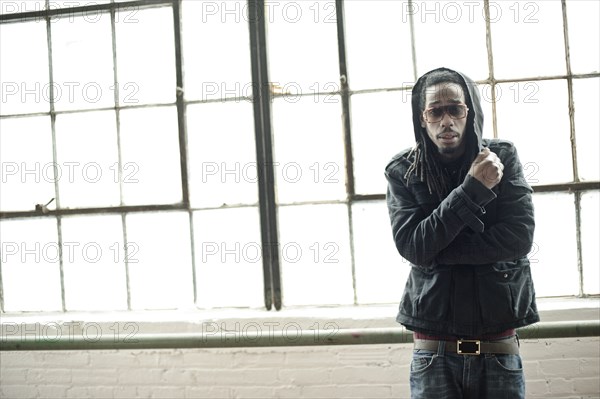 Black man standing at window